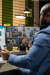 © DC Studio - African american man attending a meeting on remote video call, discussing with business partners about a new collaboration to expand the company internationally. Web chat event.
