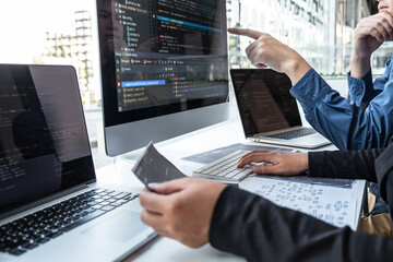 team of developer programmer working on project in software development computer in it company offic