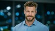 © BOJOShop - Confident middle aged man with beard smiling light blue patterned shirt blurred city lights background