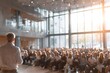 © grey - CEO addressing employees in a town hall meeting with a large audience, representing leadership and corporate communication.