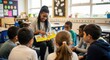 © Von - A teacher reads a book to a group of children in a classroom.