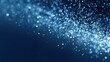 © mila103 - A collection of shimmering blue particles floats gracefully against a dark background. This magical display evokes feelings of wonder and tranquility.