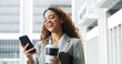 © peopleimages.com - Business woman, phone and texting in city with smile, coffee cup and notification for chat on break. Person, happy and smartphone on mobile app, scroll or contact on social media with drink in town