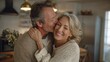 © Johannes - smiling mid age older couple hugging and kissing standing at home happy senior adult mature classy husband and wife embracing bonding enjoying wellbeing and love in new modern house no logos no brand