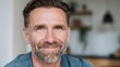 © Johannes - smiling handsome middle aged 50s single man looking at camera standing at home happy satisfied confident senior mature european male model posing indoors for close up face headshot portrait no logos