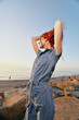 © SHOTPRIME STUDIO - lifestyle woman in modern boho-western denim street style wearing a red bandana at the beach with warm film color tones and relaxed pose