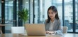 © Sajeduil - Close up Asian business woman working on a laptop in a professional office