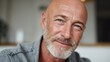 © Johannes - smiling handsome middle aged 50s single man looking at camera standing at home happy satisfied confident senior mature european male model posing indoors for close up face headshot portrait no logos
