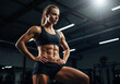 © Vasiliy - Woman with defined abs in confident power pose showcasing athletic physique in modern gym. Athletic achievement inspiration content for fitness center promotional campaigns