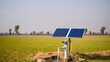 © Elena - Solar powered water pump is in a field