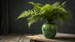 © Asif Rubayet - Lush green fern fronds in a decorative green glass vase on a rustic wooden table