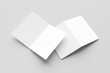 © Hasrizal - Bifold mockup. A pair of white bifold cards, one open and one closed, casting shadows isolated on a light grey background