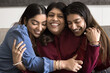 © fizkes - Family bonds. Thankful loving grownup daughters hugging happy smiling aged mom snuggle close from both sides to beloved parent share affectionate moment of pure love emotional connection appreciation