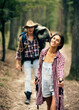 © Volodymyr - Young couple hiking in a forest. Couple hiking along a forest trail. Travel, healthy lifestyle. Hiking, camping, eco-tourism, and active vacations. Hiking on nature.