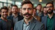 © Alex Pios - Group of diverse men showing mustaches and blue ribbons promoting mens health awareness during November fundraising gathering
