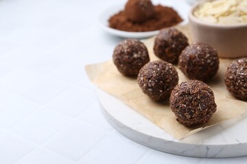 Wall Mural - making homemade candies. chocolate balls and ingredients on white tiled table, closeup. space for te