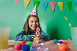 © lithiumphoto - Happy smiling girl celebrating eight birthday sitting at a table