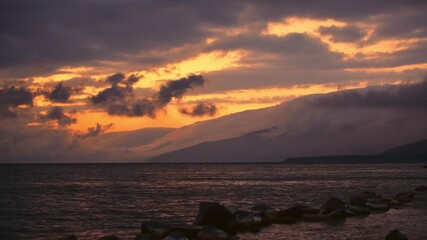 Wall Mural - Beautiful bright timelapse sunset with clouds over mountains lake.