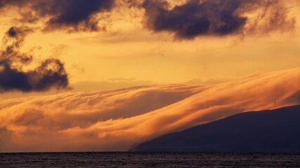 Wall Mural - Beautiful bright timelapse sunset with clouds over mountains lake.