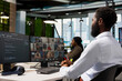 © DC Studio - Tech company office coworkers working together via videocall, doing brainstorming on backup solutions to protect against data loss. African american man coding during online teleconference
