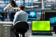 © DC Studio - Close up of green screen mockup laptop in data center used by engineers doing troubleshooting. Chroma key isolated screen notebook in server hub used by workers auditing systems