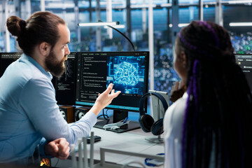 Data center programmers collaborating, working on neural networks AI databases. Server room colleagues talking, using machine learning artificial intelligence on PC to do algorithms improvements