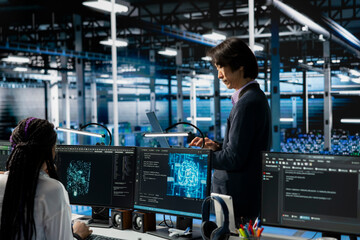 data center developer monitoring ai systems, adjusting machine learning parameters. server hub it em
