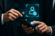© Jairo - Business handshake with gear icon hologram over smartphone / Aperto de mãos de negócios com holograma de ícone de engrenagem sobre smartphone