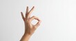 © INYUMI STD - Isolated hand gesture of perfection and agreement, the OK sign in soft studio light.