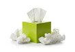 © radesign - Green tissue box with used tissues scattered around it on white background