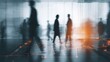 © andyaziz6 - Blurred silhouettes of people walking through a busy indoor space with vibrant lighting and reflections