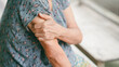 © Oporty786 - Senior woman suffering from arm pain, holding her shoulder due to muscle ache or arthritis. Concept of elderly health problems, joint pain, aging care, and medical treatment.
