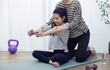 © DN6 - A mother is training her daughter, Fit young people lift dumbbells and weights in a home, exercising for a healthy lifestyle concept