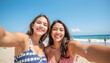 © Atchariya63 - Closeup happy female friends smiling selfie beach summer vacation ocean blue sky joyful