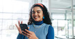 © peopleimages.com - Woman, smartphone and happy with texting at startup, scroll and notification for deal at media company. Person, phone and smile on break at office, web chat and social network at creative agency