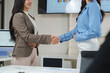 © crizzystudio - Businesswomen shaking hands after successful meeting in office