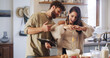 © Lime25/peopleimages.com - Couple, tablet and baking in kitchen with egg, online tutorial and help with instructions for recipe. Home, man and woman cooking with technology for ingredients, food guide and laugh for meal prep