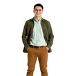 © Secrets inside - Young man wearing glasses, a light green shirt, an olive green jacket, and brown pants, standing with hands in pockets and smiling confidently
