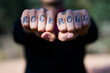 © TrueShot | Westend61 - Fingers tattooed with 'Rock and Roll'