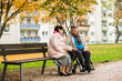 © TrueShot | Westend61 - Senior woman sitting on bench next to husband in wheelchair