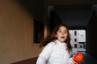 © TrueShot | Westend61 - Scared girl with pumpkin basket in Halloween