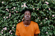 © TrueShot | Westend61 - Young man with eyes closed relaxing amidst plants