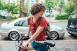 Young man riding bicycle on pavement turning around