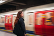 © TrueShot | Westend61 - Young woman standing in front of subway at platform