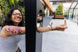 © TrueShot | Westend61 - Smiling lesbian woman showing middle finger