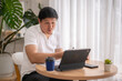© Wasana - Asian freelancer working from home having a video call on tablet