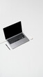 © Tommy - Open laptop with wireless mouse and pen placed on clean white desk background.