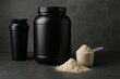 © Enigma - Whey protein powder scattered across measuring scoop, jar, and shaker, presenting professional fitness nutrition setup against minimalist gray backdrop