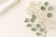 © MdSohel - Delicate White Baby's Breath and Eucalyptus Sprigs on Cream Background floral flower