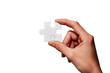 © Cyra - A single, white jigsaw puzzle piece held by a hand